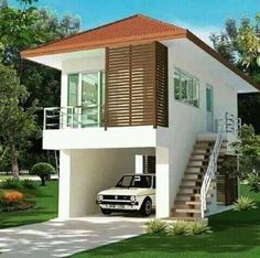 a small white car is parked in front of a two story house with stairs leading up to the second floor