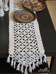 crocheted table runner with plates on it