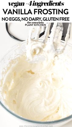 a white bowl filled with vanilla frosting next to a whisk on a fork