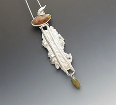 This is a very special piece and one of my favorites ever made.  Movement and dance were my inspiration for this Dancing Lady Pendant.  It was made from sterling silver and sterling silver cast in cuttlefish bone.  The stones were purchased at a Rock Shop in Roswell, NM.  I am unsure as to what kind of stones they are as I was going more for color and pattern.  As with most things I make, I have worn this pendant several times and always receive compliments on how it looks.  Because the upper hi Scrimshaw Sterling Pendant Jewelry, Eclectic Jewelry, Mixed Metal Jewelry, Colored Stones, Free Flowing, Pin Backs, Metal Pendant, A Rock, Art Jewelry