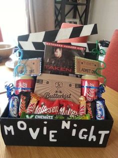 the movie night gift basket is ready to be filled with movies, snacks and candy