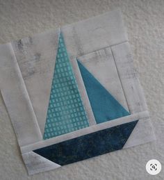 a close up of a piece of fabric with a sailboat on it