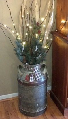 a tin can with lights and branches in it