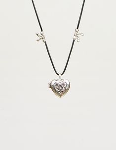 Discover the enchanting beauty of our Sunny Locket Necklace. This exquisite piece features an embellished heart with intricate front engraved detail, exuding a charming appeal. With its antiqued silver-tone finish, this western-style locket necklace adds a touch of rustic elegance to any outfit. Crafted in a boho jewelry design, it comes complete with a stylish cord necklace. Experience the perfect blend of vintage allure and contemporary fashion with this captivating accessory. Stacked charms a Scissors Jewelry, En Route Jewelry, Heart Locket Necklace, Heart Locket, Girly Jewelry, Jewelry Inspo, Dream Jewelry, Locket Necklace, Pretty Jewellery