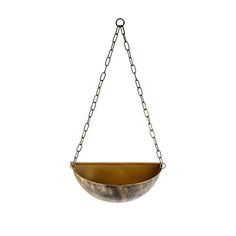 a metal bowl hanging from a chain on a white background