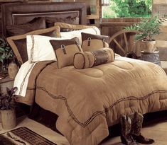 a bed with brown and white comforters in a room