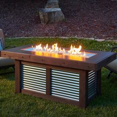 a fire pit sitting on top of a lush green field