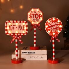 three red and white stop signs with lights on them