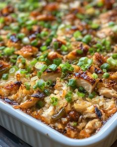 a casserole dish with chicken and green onions