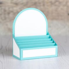 a small blue and white business card holder