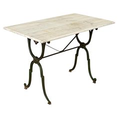 a white table with wrought iron legs and a marble top, isolated against a white background