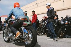 a man riding on the back of a motorcycle in front of other motorcyclists