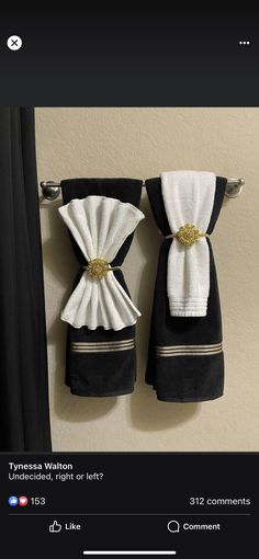 two black towels hanging on the wall next to each other