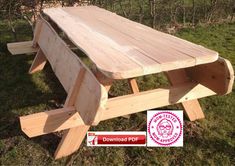 a wooden picnic table sitting in the grass