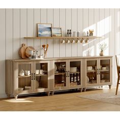 a wooden cabinet with glass doors and shelves on the top, in front of a white wall