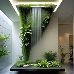 a very nice looking room with some plants on the wall and water falling from it