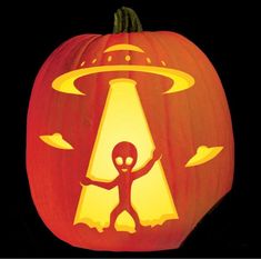 a glowing pumpkin with an alien on it