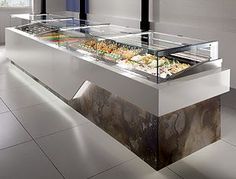 a buffet table with food on it and chandelier hanging from the ceiling