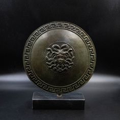 a bronze plate with an intricate design on it