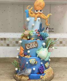 a cake with an octopus on top and other sea creatures around the bottom, is displayed on instagram