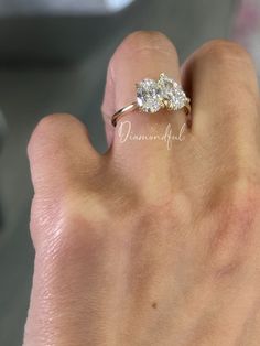 a woman's hand with a diamond ring on it