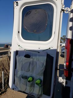 the back end of a white truck with two pairs of green shoes in it's cargo compartment