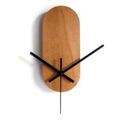 a wooden clock with black hands on a white wall