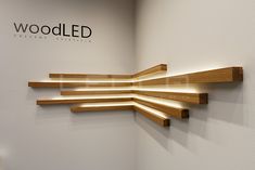 a white wall with some wooden shelves on it and a sign that says woodled