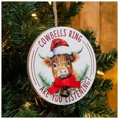 a christmas ornament with a cow wearing a santa hat