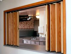 an open sliding door in front of a kitchen