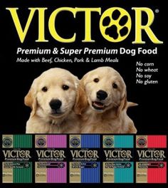 two puppies sitting next to each other in front of a box of victory dog food