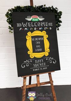 a chalkboard sign that says welcome to friends the one where i am a baby