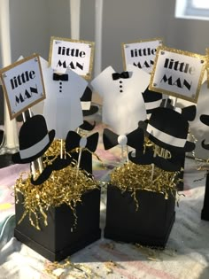 these little man centerpieces are black and gold