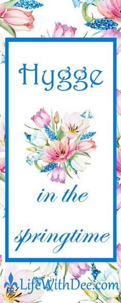 a blue frame with pink flowers and the words hygge in the springtime