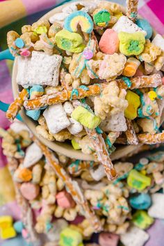 a bowl filled with lots of candy and marshmallows on top of a checkered table cloth