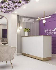 a reception area with purple flowers on the ceiling and a white counter in front of it