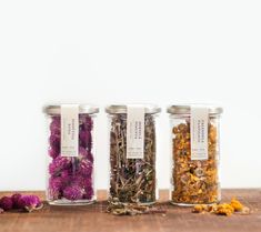 three jars filled with different types of flowers