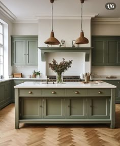 a kitchen with green cabinets and wooden floors