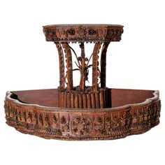 an ornately carved wooden fountain on display