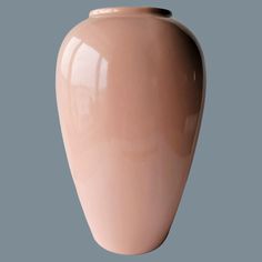 a large pink vase sitting on top of a table