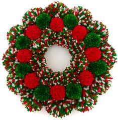 a christmas wreath with red and green pom - poms around it on a white background