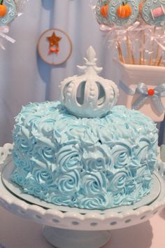 a blue and white cake sitting on top of a table