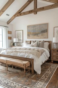 a large bed sitting in a bedroom on top of a wooden floor next to a window