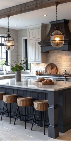 a large kitchen with an island in the middle and stools at the counter top