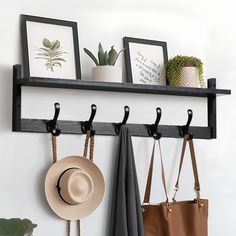 two hats and three purses are hanging on the wall next to a coat rack