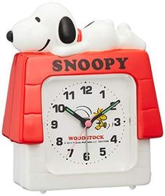 a snoopy alarm clock with the word snoopy on it