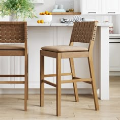 two wooden stools sitting in front of a kitchen island