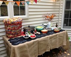 a table that has some food on top of it with bunting and flags around it