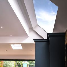 an open room with skylights and black columns