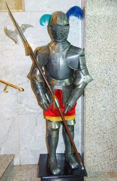 a statue of a knight holding two spears